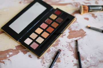Nude palette of shadows and brush. Fashion, beauty concept. Professional makeup decorative...