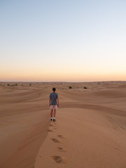 Fototapeta na wymiar Person on sand dunes in dubai UAE summer