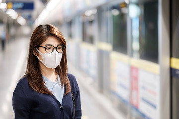 young Asian woman wearing protection mask against Novel coronavirus or Corona Virus Disease (Covid-19) at airport, is a contagious virus that causes respiratory infection.Healthcare concept