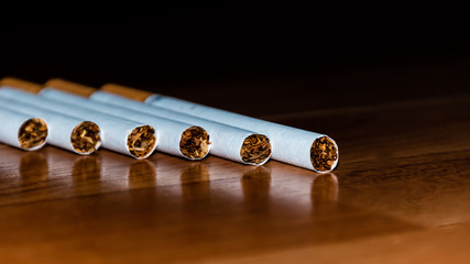 A close-up shot of six cigarettes lying on the table