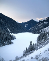 Fototapeta premium Kolsay Mountain Lake at winter sunrise
