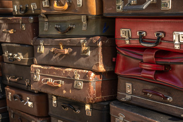 Vintage suitcases stacked in a heap. Traveling concept. Background