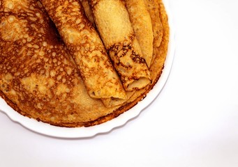 Top view of fresh fried round pancakes that lie in a plate