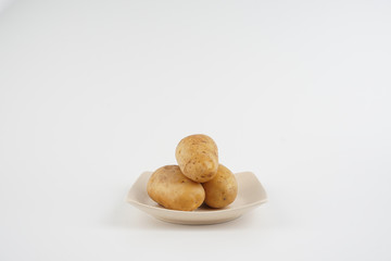 Fototapeta na wymiar Potatoes over white background. Food concept