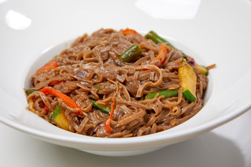 noodle with vegetables on the wooden background