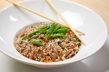 noodle with vegetables on the wooden background