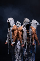 Fototapeta na wymiar Four muscular gothic man standing shirtless on black background. Concept of mystery and secret