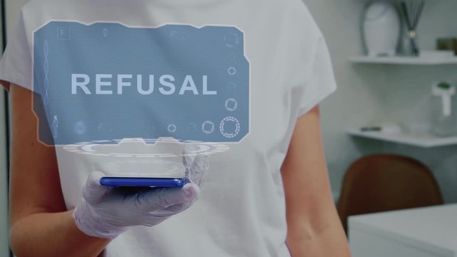 Doctor in medical glove against background of doctor's office with HUD hologram text Refusal. Hand holds futuristic holographic gadget. Medical technology concept of the future