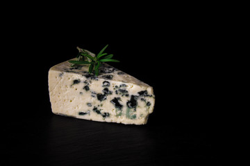 Roquefort cheese, ripe cheeses, blue cheese, a dark background