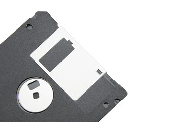 Part of an old black floppy disk for an FDD drive. Digital vintage drive. 1.44 megabyte retro data warehouse. Diskette on a white isolated background. Good quality close-up.