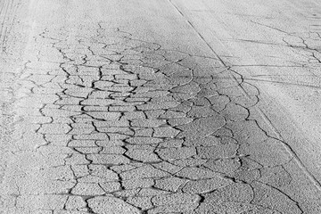 Texture of gray cracked asphalt. Abstract backdrop for design.
