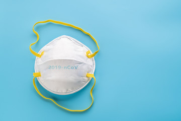 White surgical mask on blue background