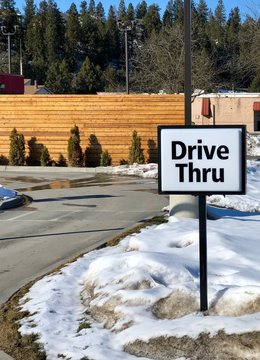 Drive Through Sign Next To A Fast Food Restaurant 