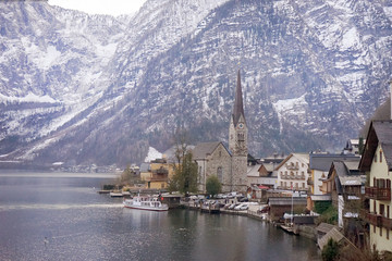Fototapeta na wymiar Hallstatt heritage village landmark for tourism sightseeing check point. Houses with tradition style old European architecture building on right side and clear lake on left. During cold winter season.