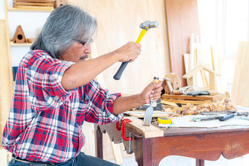 Asian carpentry using hammer and chisel to produce wood products. The wood industry. Invention and...