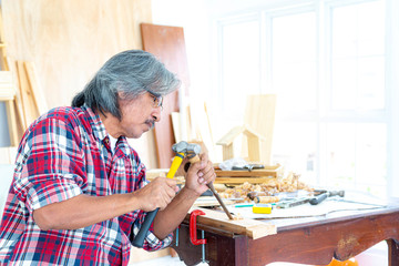 Asian carpentry using hammer and chisel to produce wood products. The wood industry. Invention and...