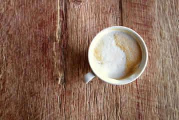 Cappuccino coffee on an old rustic wood table