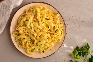 Pasta Fettuccini. Light background, top view, a beautiful plate. Delicious vegetarian pasta lunch.