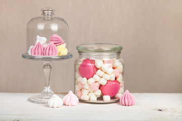 Marshmallows and meringues on a wooden table.
