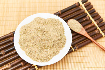 A pile of rice bran in a bamboo basket