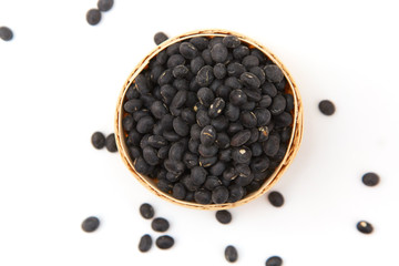 A pile of black beans in the bamboo basket