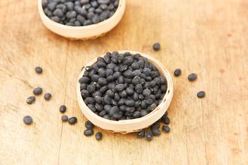 A pile of black beans in the bamboo basket