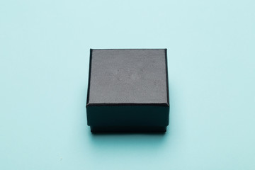 Mini black box product packaging isolated on blue background.