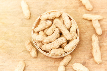 A pile of peanuts in a bamboo basket