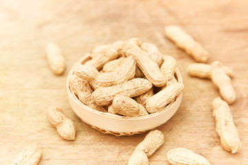A pile of peanuts in a bamboo basket