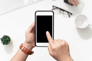 Top view image of woman' s hands holding smart phone and touch screen on blank screen mobile for mockup