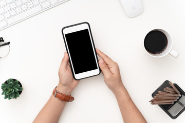 Top view image of woman' s hands holding smart phone and touch screen on blank screen mobile for mockup