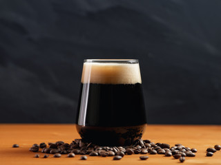 Craft beer coffee stout in a glass on a wooden table