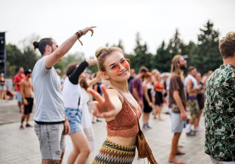 Beautiful young woman dancing at summer festival. - obrazy, fototapety, plakaty