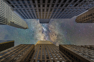 New York City midtown modern office skyscrappers buildings againsta starry night sky. Bottom view.