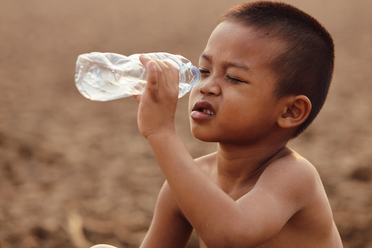 Asian boys are currently lacking clean water for consumption.