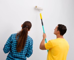 Young family painting the walls in DIY concept