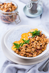 Chia pudding bowl with homemade granola and kumquats for breakfast