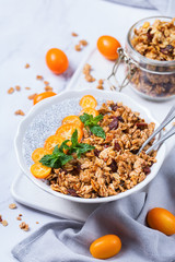 Chia pudding bowl with homemade granola and kumquats for breakfast