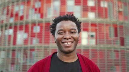 Smiling mature man wearing red coat and looking at camera