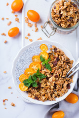 Chia pudding bowl with homemade granola and kumquats for breakfast