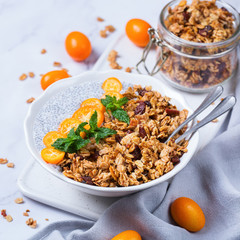 Chia pudding bowl with homemade granola and kumquats for breakfast