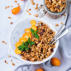 Chia pudding bowl with homemade granola and kumquats for breakfast