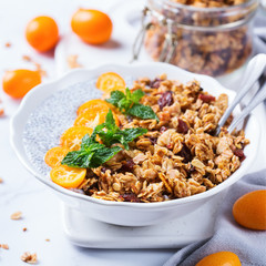 Chia pudding bowl with homemade granola and kumquats for breakfast