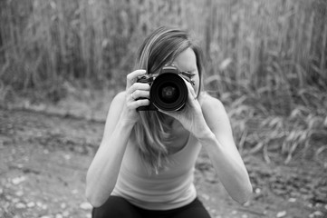 Female photographer taking photo directly at the camera