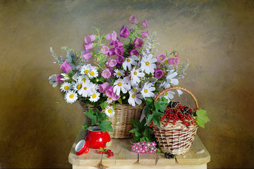Still life with wildflowers in a basket, ripe berry