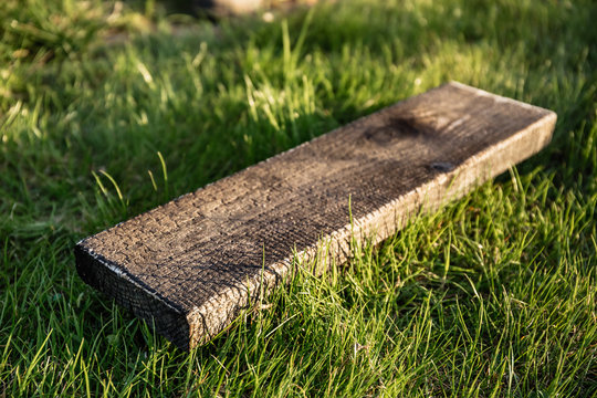 Pine board is burned as a method of processing from beetles. Aged decorative board. Facing material.
