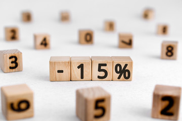 -15% - from wooden blocks with digits , -15% sale concept, white background random numbers around