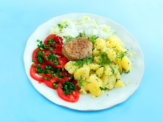 baked meat cutlet with potatoes and salads