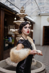 Portrait of 20s style festive beauty in a restaurant