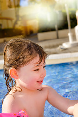 cute little girl playing in the pool